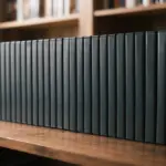 A collection of unbranded, plain dark media cases (like DVD or Blu-ray) meticulously arranged on a warm